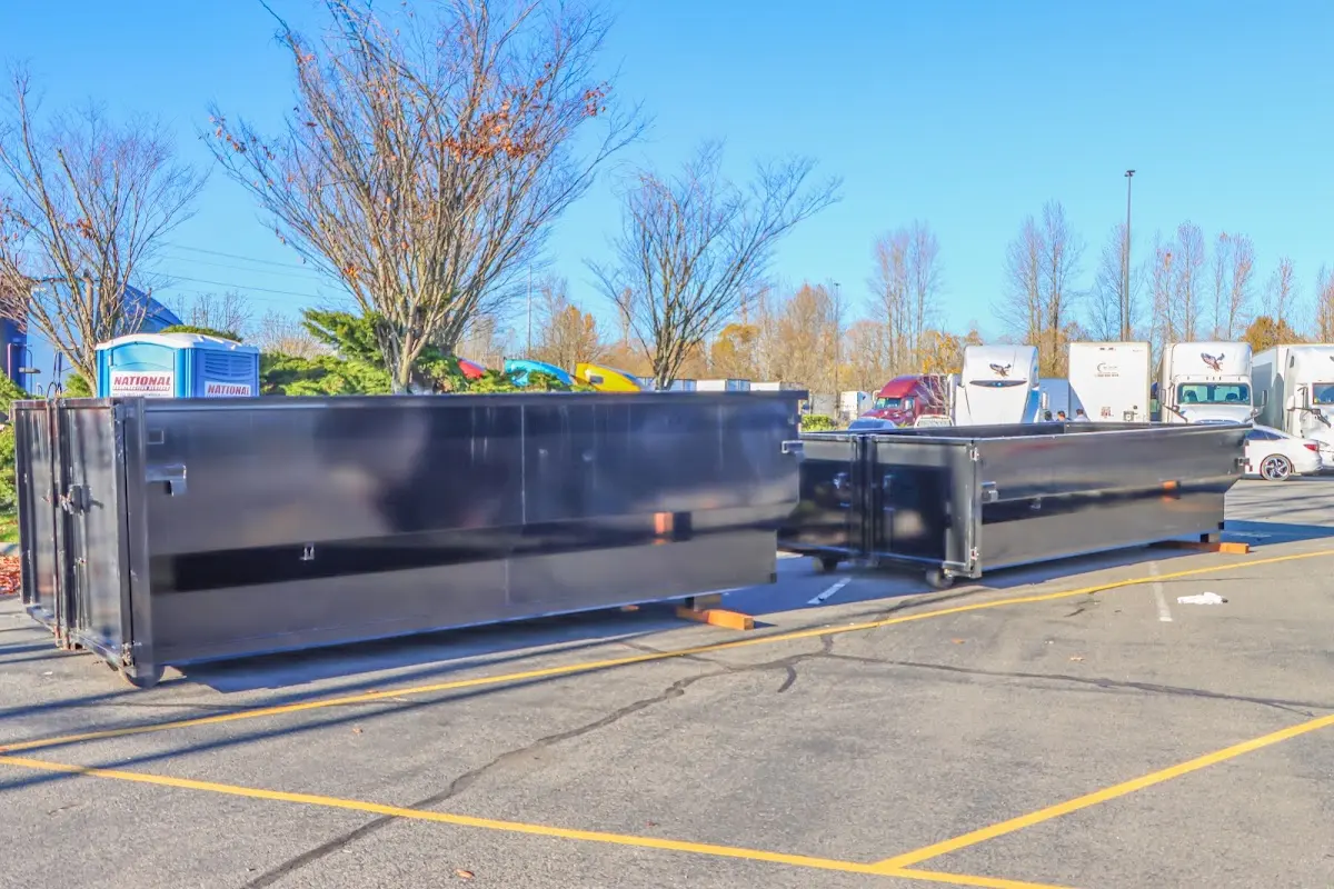 Professional dumpster rental service with roll-off container on residential driveway in North Plainfield